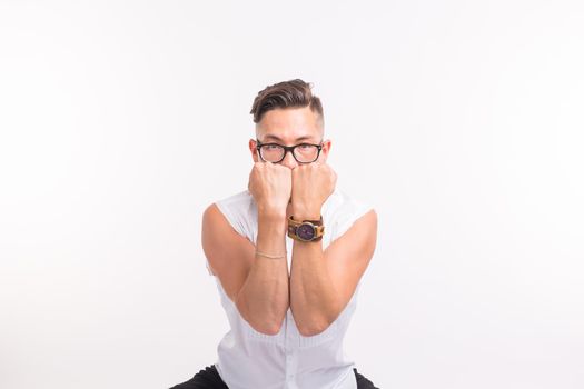 People, clothing and style concept - young handsome man posing in white shirt on white background.