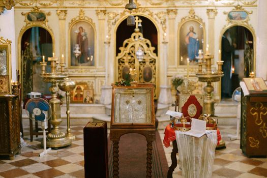Iconostasis around the altar in the church with white columns. High quality photo