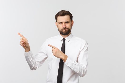 Bearded serious businessman pointing finger at you. Isolated on grey studio background.