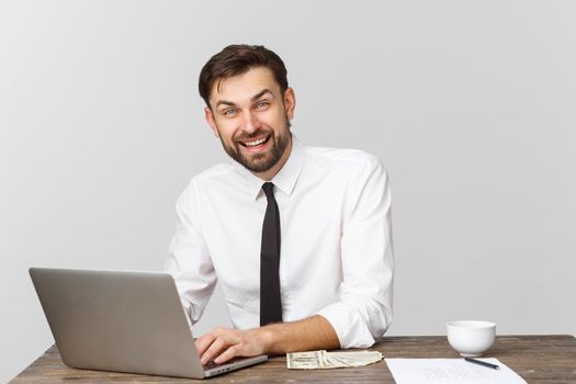 Young businessman in a workplace with surprise and shocked facial expression.
