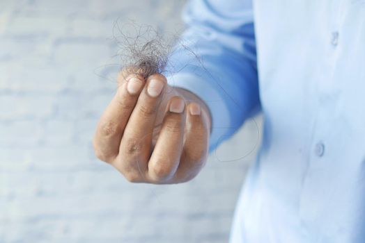 man hold his list hair close up ,