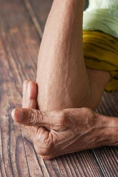 senior women suffering pain on elbow .