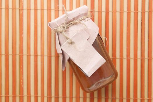 fresh honey in a glass jar with a paper empty label ,