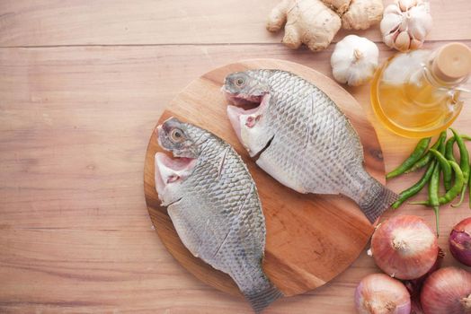 raw fresh sea fish on plate on table