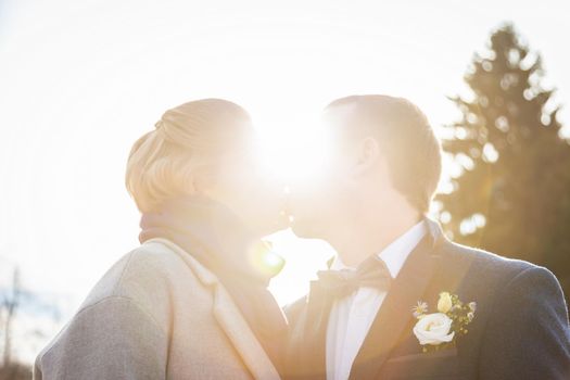 Two human silhouettes kissing in the sun . High quality photo