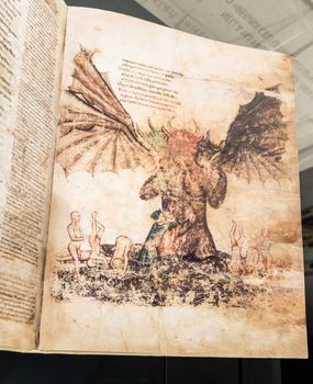 FLORENCE, ITALY - circa July 2021. Antique manuscript sheet from a gothic book with satanic hell illustration, 16th Century copy.