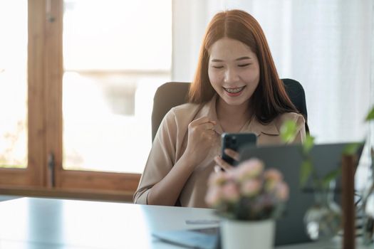 portrait of cheerful asian woman are happy while using smartphone for video call. business concept.