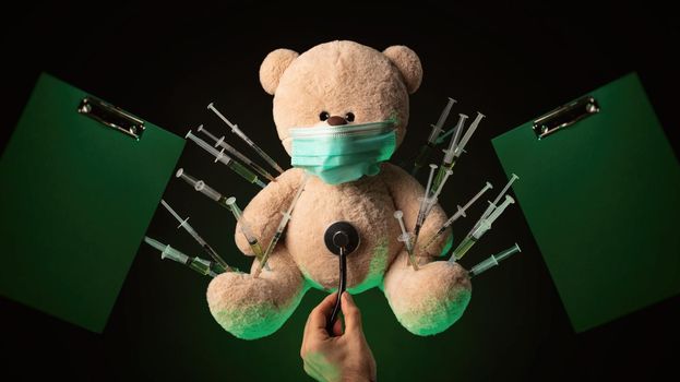 the children's vaccination against the covid19 virus and vaccinations on the example of a teddy bear