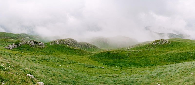 Mountains in dense fog in Durmitor National Park. Montenegro, north. High quality photo