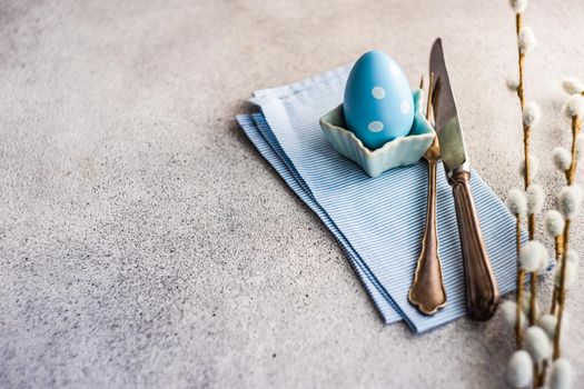 Festive table setting for holiday Easter dinner in blue color