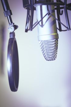 Professional microphone suspended in the air of professional studio