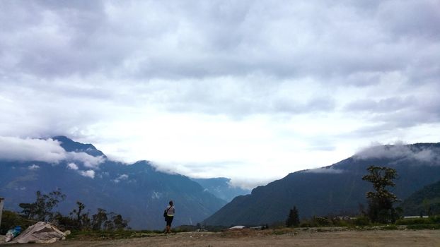 girl in mountain, view over the town of Banos in Ecuador