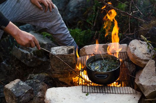 Friends camping eating food concept. A warm fire you to drink and camp in the mountains of Chiprac, north of Lima Peru