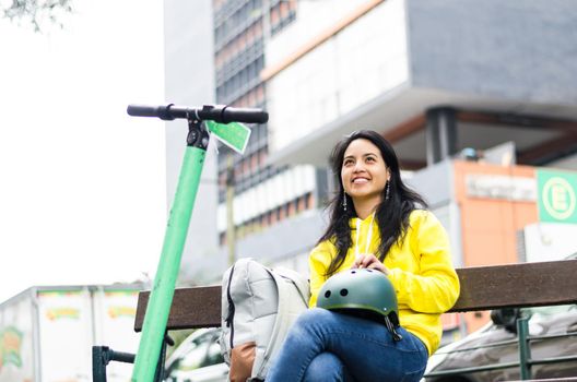 Portrait of cycling woman holding biking protective helmet ready for workout