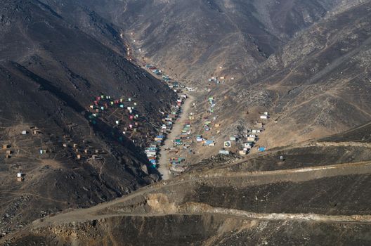 The houses and apartments are built in a poor neighborhood in Lima, Peru.