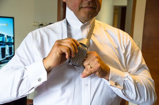 Close up of a business man fixing his tie