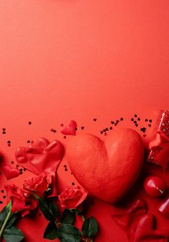 Red solid background with red hearts, gifts and candles. The concept of Valentine Day.