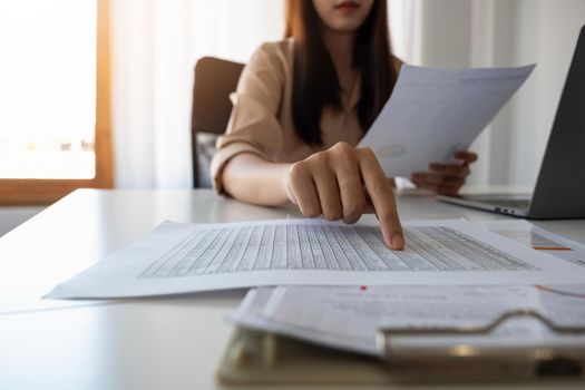 Close up business woman accountant or financial expert analyze business report graph and finance chart at corporate office. Concept of finance economy, banking business and stock market research.