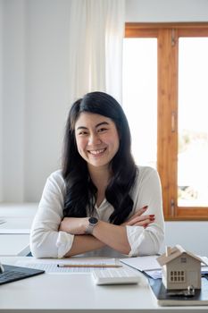 Portrait asian business, finance and employment, female successful entrepreneurs concept. Confident professional female real estate broker showing good deal, pointing upper right corner and smiling.