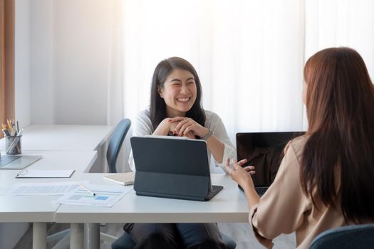 Happy asian businesswoman putting forward his suggestions to colleagues. Startup business team on meeting in modern bright office.