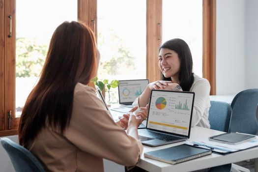 Asian business adviser meeting to analyze and discuss the situation on the financial report in the meeting room.Investment Consultant, Financial advisor and accounting concept.