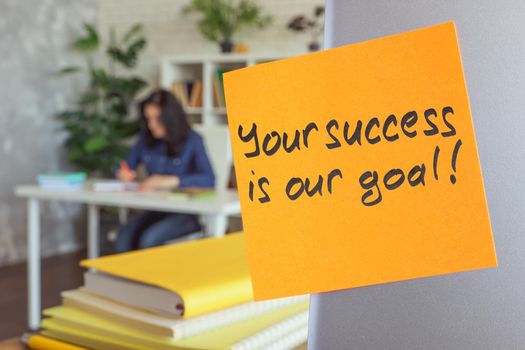 Your success is our goal motivation quote on a sticker.