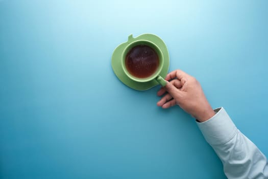hand holding cup of green tea with copy space ,