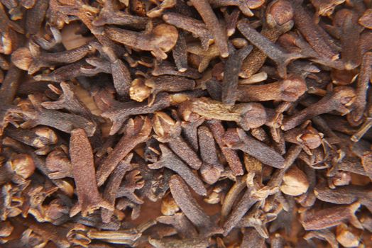 cloves on a spoon on table close up .