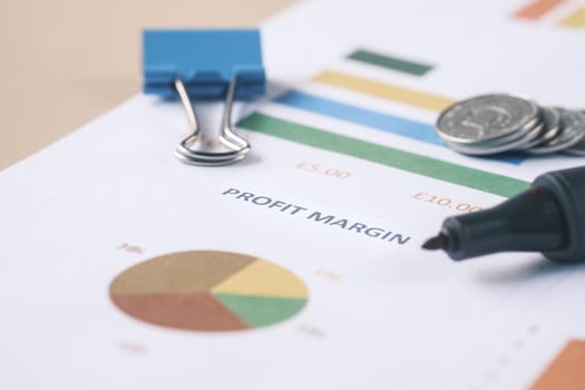 financial graph, calculator and notepad on table.