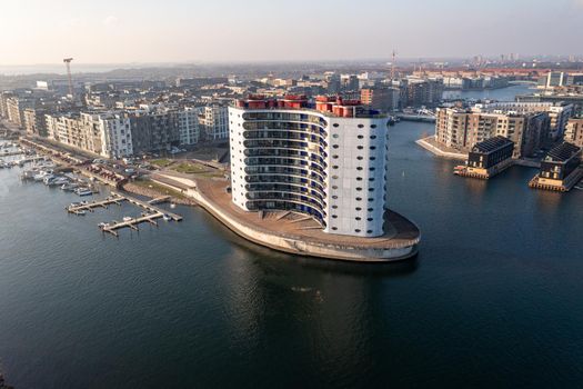 Copenhagen, Denmark - January 10, 2022: Aerial drone view of modern residential building Metropolis on Sluseholm in Sydhavn district.