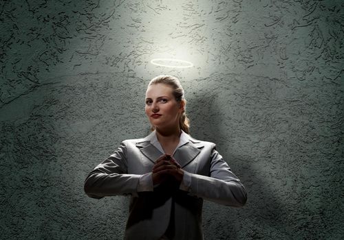 Young saint businesswoman with light above her head