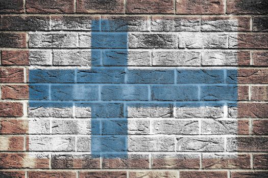 A Finland flag on old brick wall background