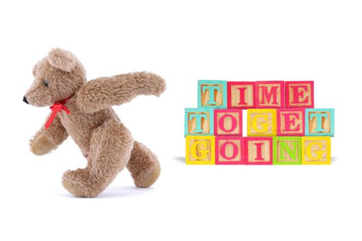 A time to get going business concept with wood blocks and teddy bear