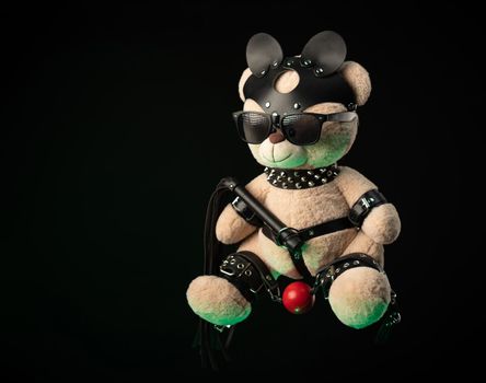 the toy Teddy bear dressed in leather belts and mask accessory for BDSM games