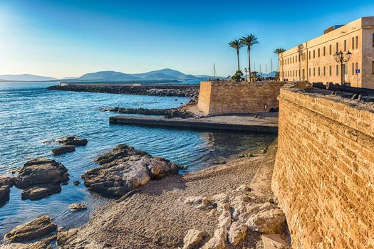 Scenic view at sunset over the historic ramparts, one of the main sightseeing in Alghero, famous center and holiday resort in northwestern Sardinia, Italy