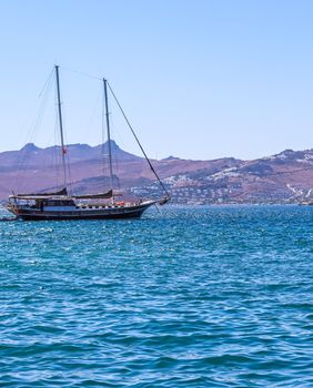 Sailboats in the blue sea against the backdrop of islands and mountains. Sports and summer vacations concept