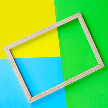 a wooden frame on a background of colored shapes