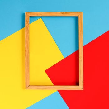 a wooden frame on a background of colored shapes
