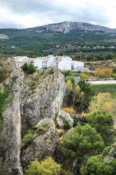 Beautiful view of Guadalest village surrounded by vegetation, mountains and the walls of the Castle