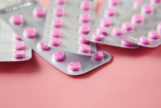 Close up of pills of blister pack on table .