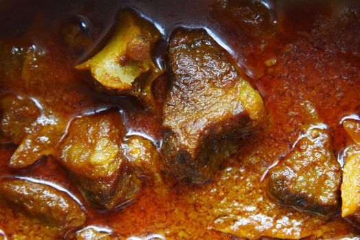 traditional Indian curry lamb masala in a bowl on table.