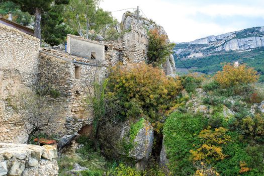 Beautiful view of Guadalest village surrounded by vegetation, mountains and the walls of the Castle