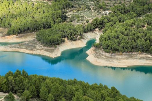 The swamp of Guadalest village surrounded by vegetation and mountains on a sunny day