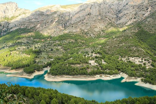 The swamp of Guadalest village surrounded by vegetation and mountains on a sunny day