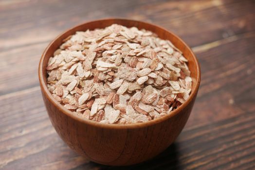 red Flattened rice in a bowl on gray background .