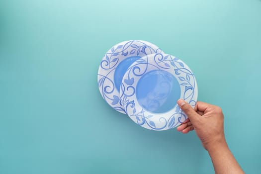 putting empty plate on table .