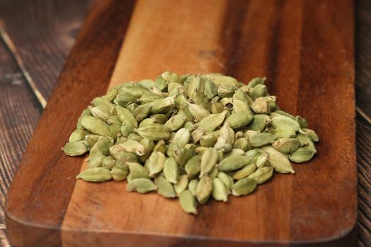 close up of Cardamom on a chopping board on table .