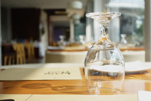 cutlery and empty plate on table against cafe background .
