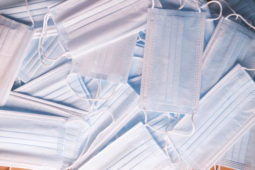 Close up of blue surgical masks on table.