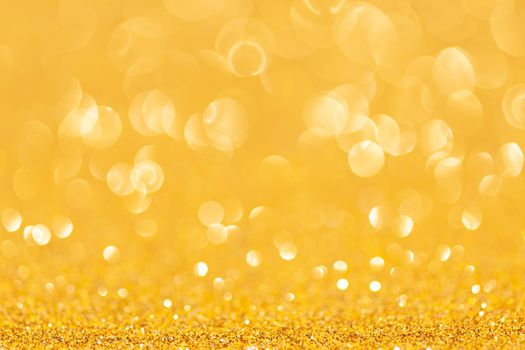 sparkles of yellow glitter abstract background. Copy space.